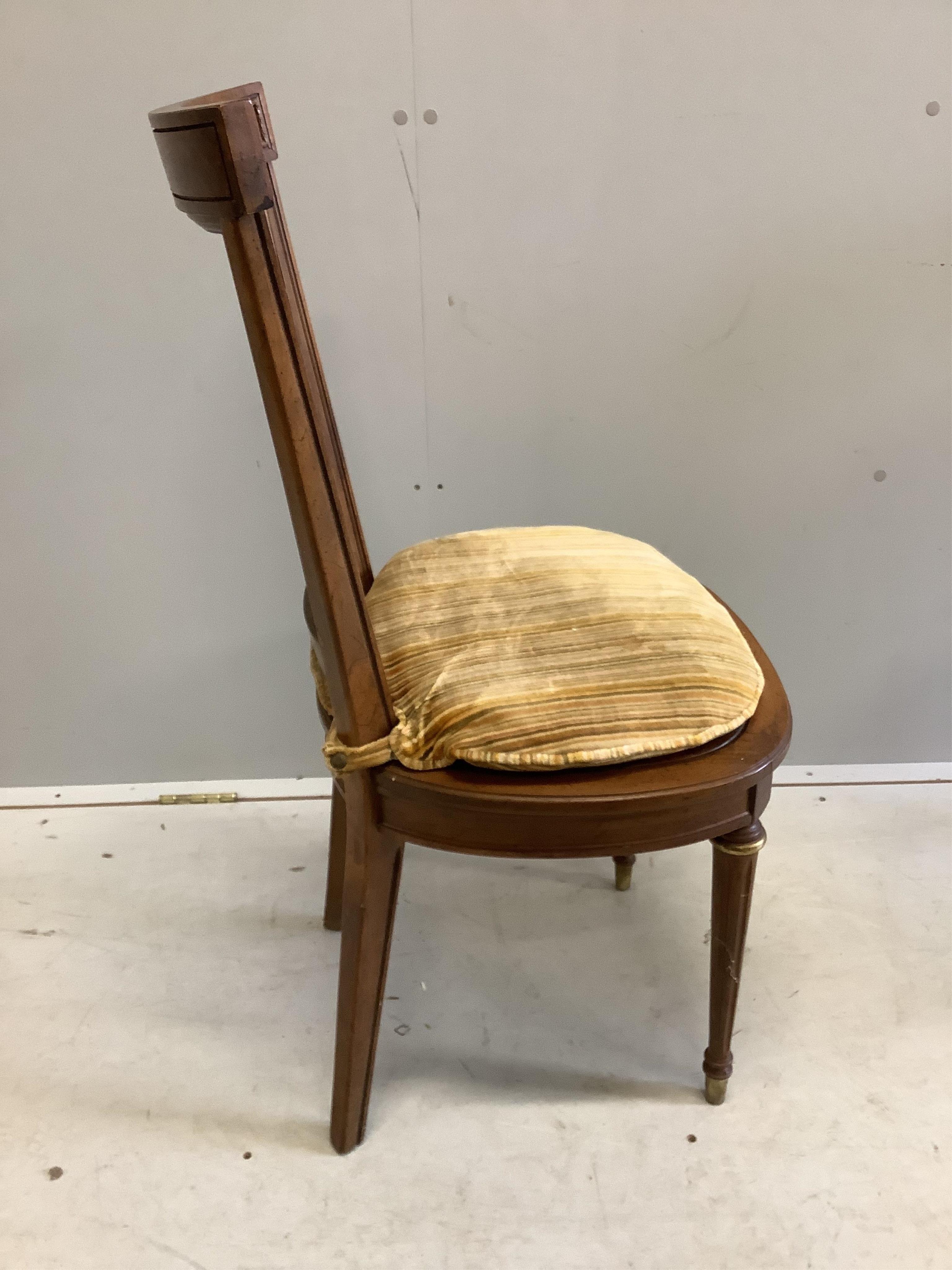 An Empire style circular mahogany games table, diameter 92cm, height 74cm and four caned chairs. Condition - fair to good